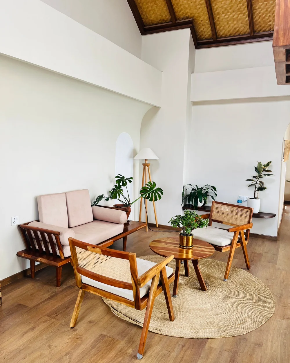 Une pièce calme aux fauteuils de bois, avec des plantes; image d'ambiance